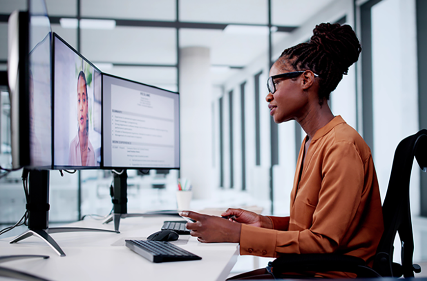 Physician recruiter sitting at a desk and talking to a candidate via video conference on her computer screen
